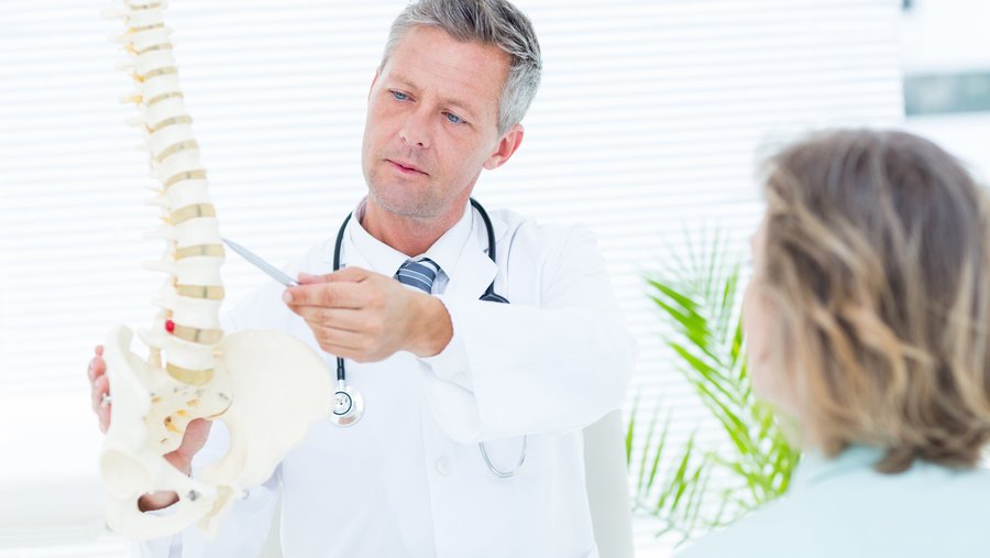  Doctor explaining spine model – RIWOspine PERCULINE radiofrequency instruments for pain therapy